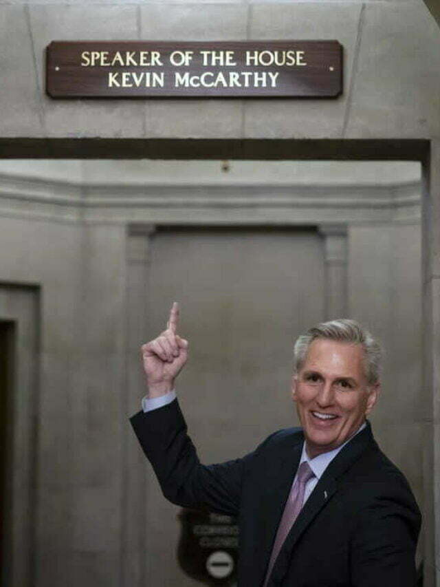 After being sworn in as the speaker of the 118th Congress, California's Kevin McCarthy, speaker of the House, points to the nameplate that has just been erected in his office.